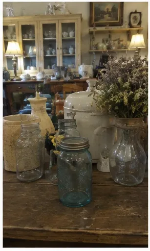Antique mason jars and crocks on a farm table